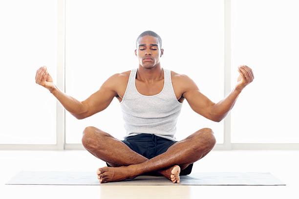 istock Healthy young man meditating on a yoga mat 182713122