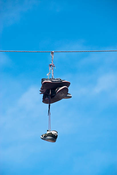 istock Sneakers Hanging by Laces on Utility or Power Line 182713247