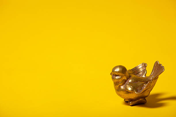 istock small golden decorative bird 182713786