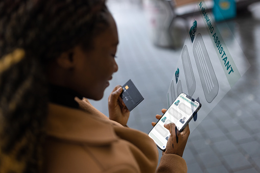 Black woman using AI e-Banking assistant