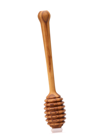 wooden honey dripper . THIS IMAGE IS ONLY AVAILABLE HERE AT ISTOCKPHOTO