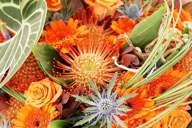 istock Orange bouquet close up with roses and daisies 182716134