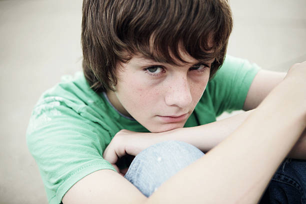 Moody Teen **Taken Prior to 9-09**A young teenage boy gloomy mood stock pictures, royalty-free photos & images
