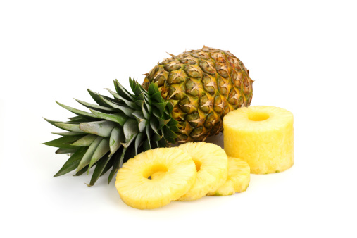 Selling pineapple fruits at local market in Mahebourg, Mauritius.