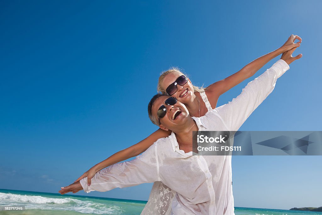 Caribbean Romance "A couple in love, a man and woman, hugging, smiling, flying" Adult Stock Photo