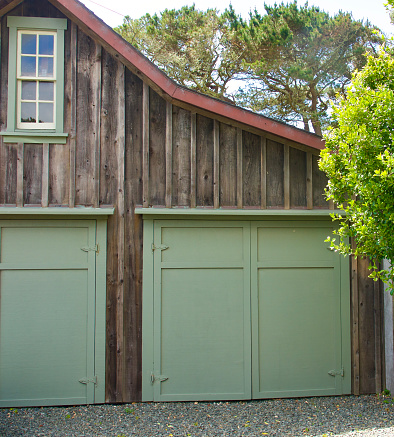 Old fashioned rustic barn with green doors
