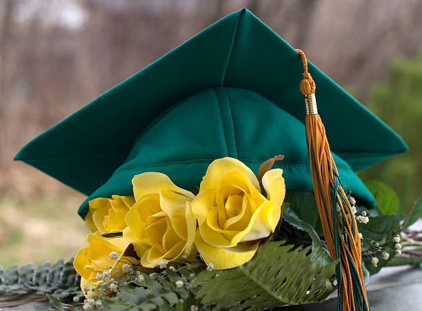 istock Green grad cap and yellow roses 182717679