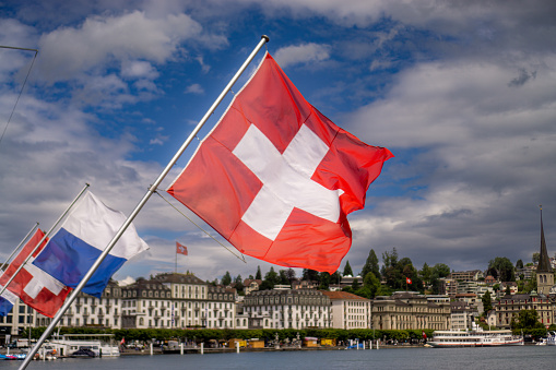 Swiss flag waving in the wind. Lucerne, Switzerland