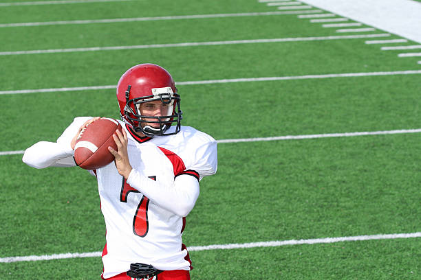 istock Football player on the field about to make a pass 182718078