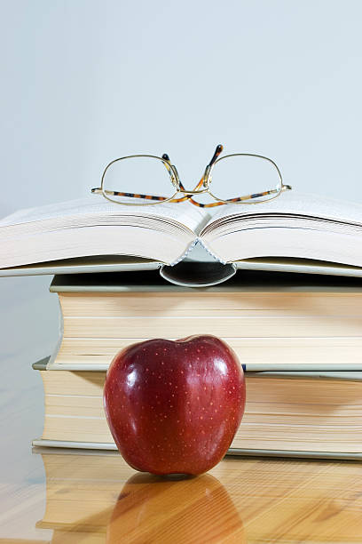istock books with apple and glasses 182718088