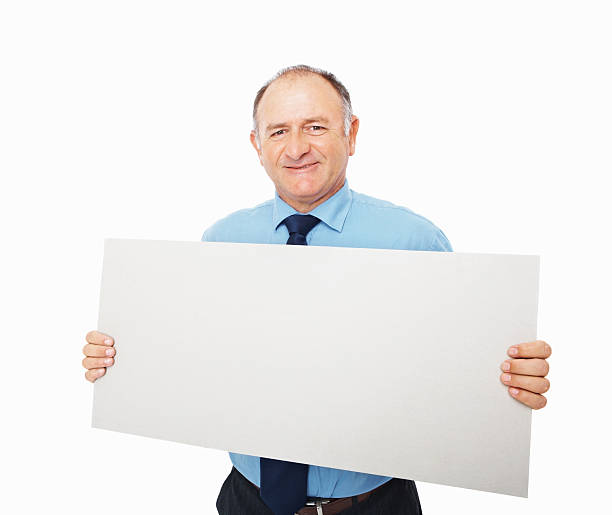 istock Smiling mature businessman holding a blank placard 182718840