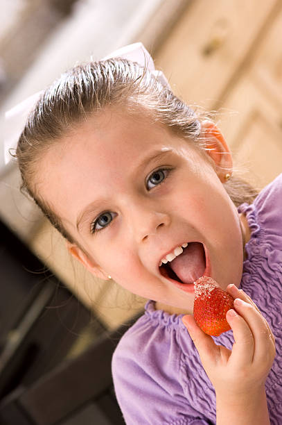 istock Girl Eating Strawberry 182719685