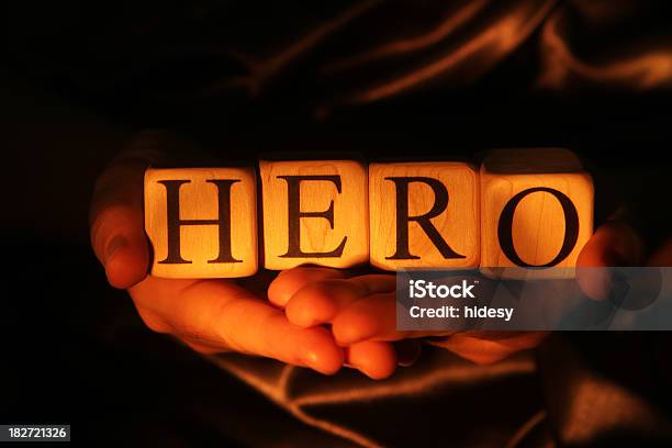 Hands Holding Lighted Blocks Spelling Hero Stock Photo - Download Image Now - Alphabet, Block Shape, Capital Letter