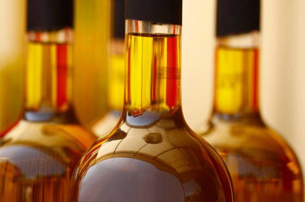 Tops of glass bottles filled with brown liquid stock photo