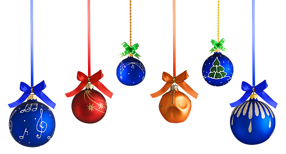 Christmas tree baubles hanging on tree branches.