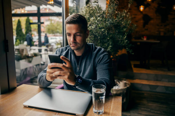 istock A man sitting in coffee shop and using his phone. 1827221988