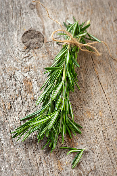 istock Fresh rosemary tied with a string on a wooden table 182722264
