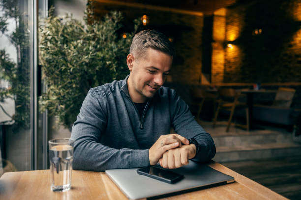 istock A man is looking at his smart watch while waiting for meeting. 1827228699
