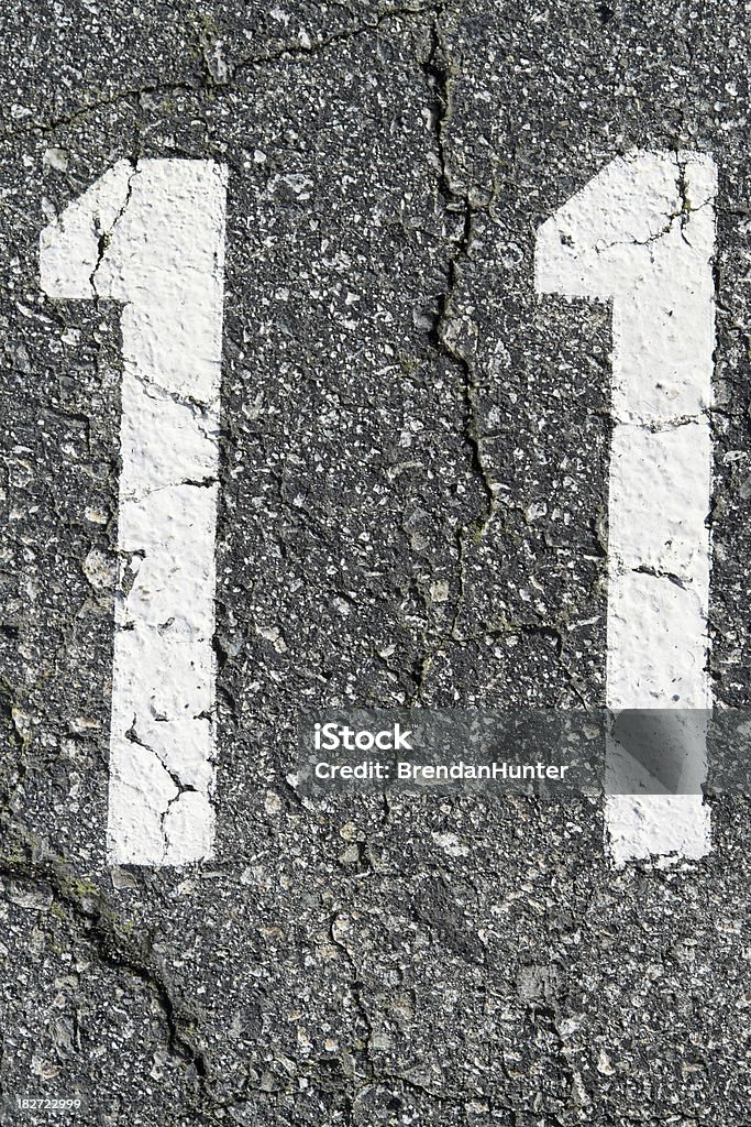 Eleven The number eleven against asphalt. Concrete Stock Photo