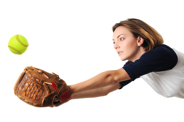 giovane donna giocatore di softball isolato su sfondo bianco - softball adult catching beautiful foto e immagini stock