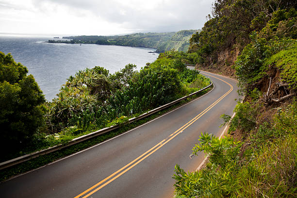 Highway to Hana "The scenic and twisty Hana Highway on the east coast of Maui, Hawaii." hana coast stock pictures, royalty-free photos & images