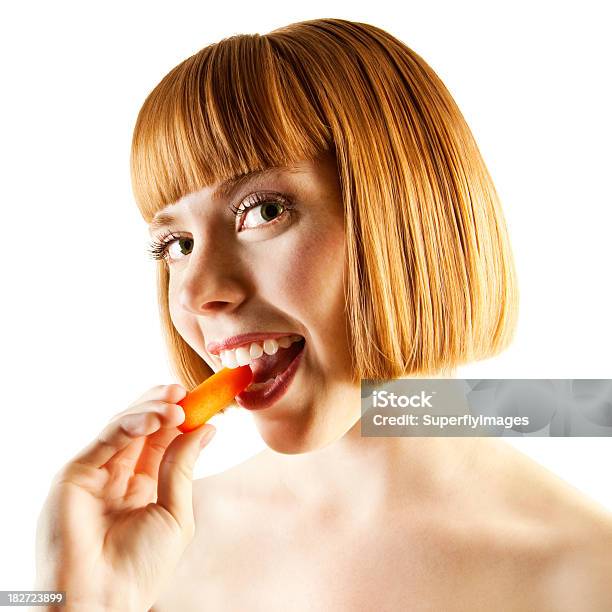 Portrait Of Vibrant Redhead Woman Biting On A Carrot Stick Stock Photo - Download Image Now