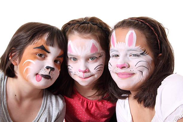 Three sisters with their faces painted Three cute sisters with their faces painted cat face paint stock pictures, royalty-free photos & images