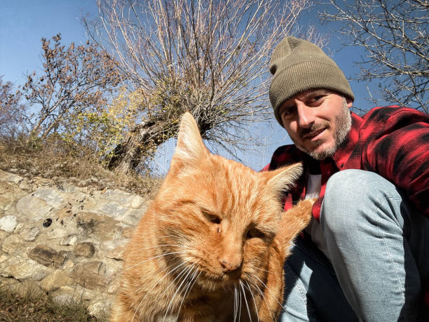istock portrait of a man with a cat 1827243350