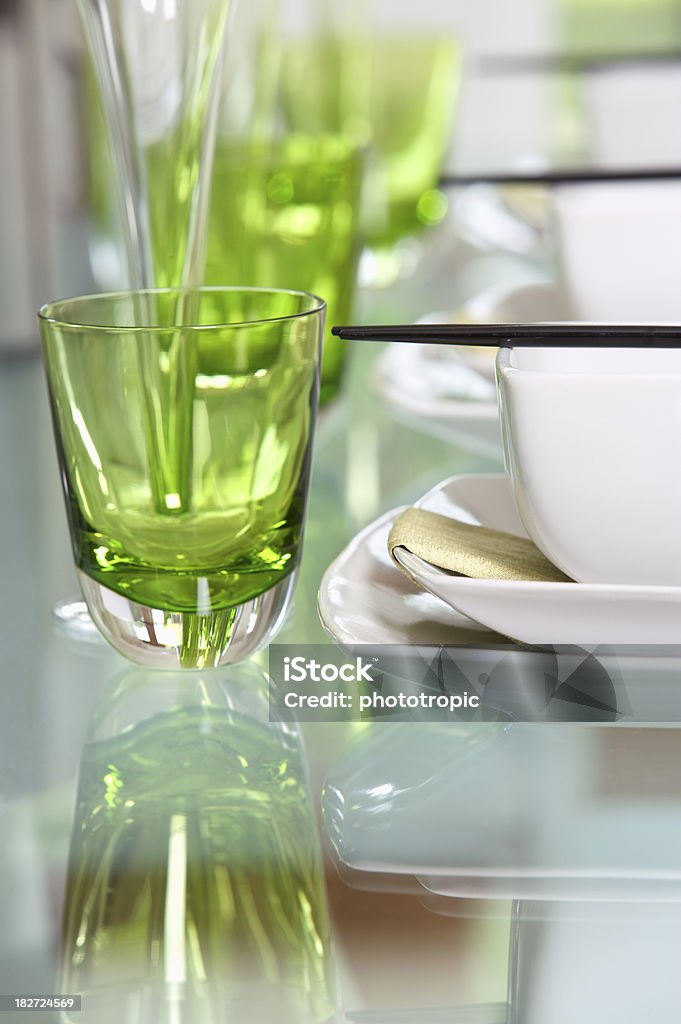 lunch setting "a table set for an oriental lunch with glasses, bowls and chopsticks. Shallow depth of field with focus on the corner of the bowl at the front. The glass table provides a soft reflection which has been made a feature in the foreground.A>ALooking for a Kitchen, Dining Room or dining related image Then please see my other images by clicking on the Lightbox link below..." Bowl Stock Photo