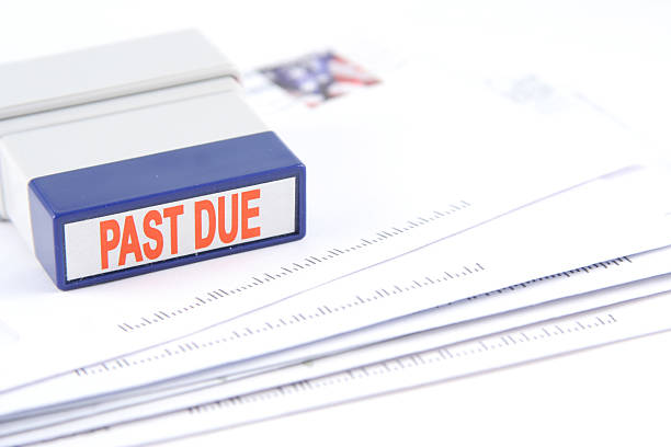 The last due bills and the stamp A stack of bills past due for payment.   collection stock pictures, royalty-free photos & images