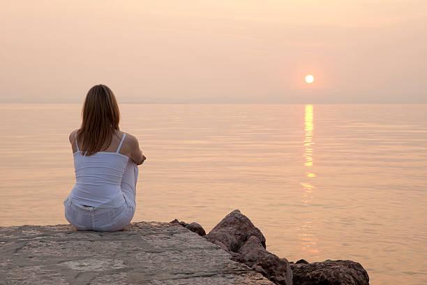 istock Woman sitting on jetty 182725976