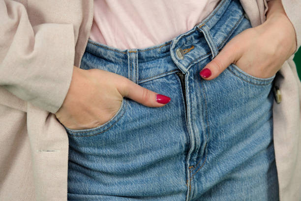 Woman wearing jeans on white background, closeup