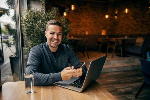 istock Portrait of a social media marketer using phone in working friendly cafe. 1827265230
