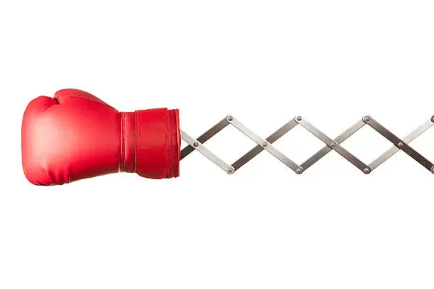 "Cartoon inspired shot of red boxing glove on a metal concertina arm. Shot on a white background, absolutely no dot in the white area, no need to cut out."