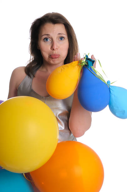 istock Dissappointed woman with deflated balloons 182727346