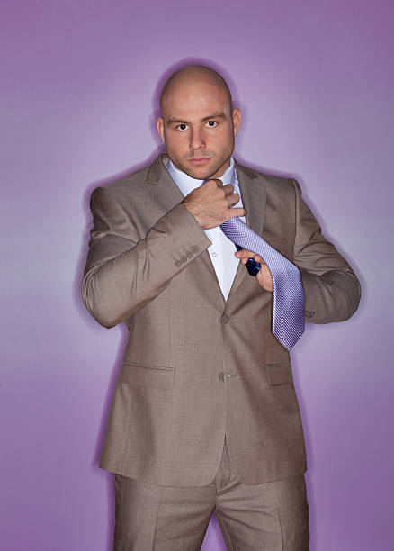 Closeup of a stylish businessman fixing his tie