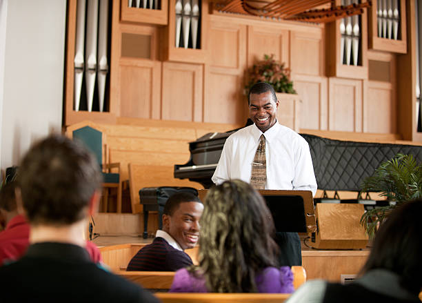 Church A group of people listening to a sermon in church - Buy credits preacher stock pictures, royalty-free photos & images