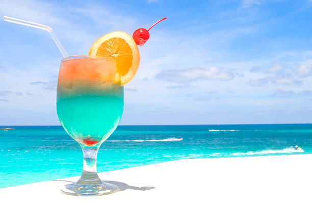 Tropical drinks with the blue ocean in the background.
