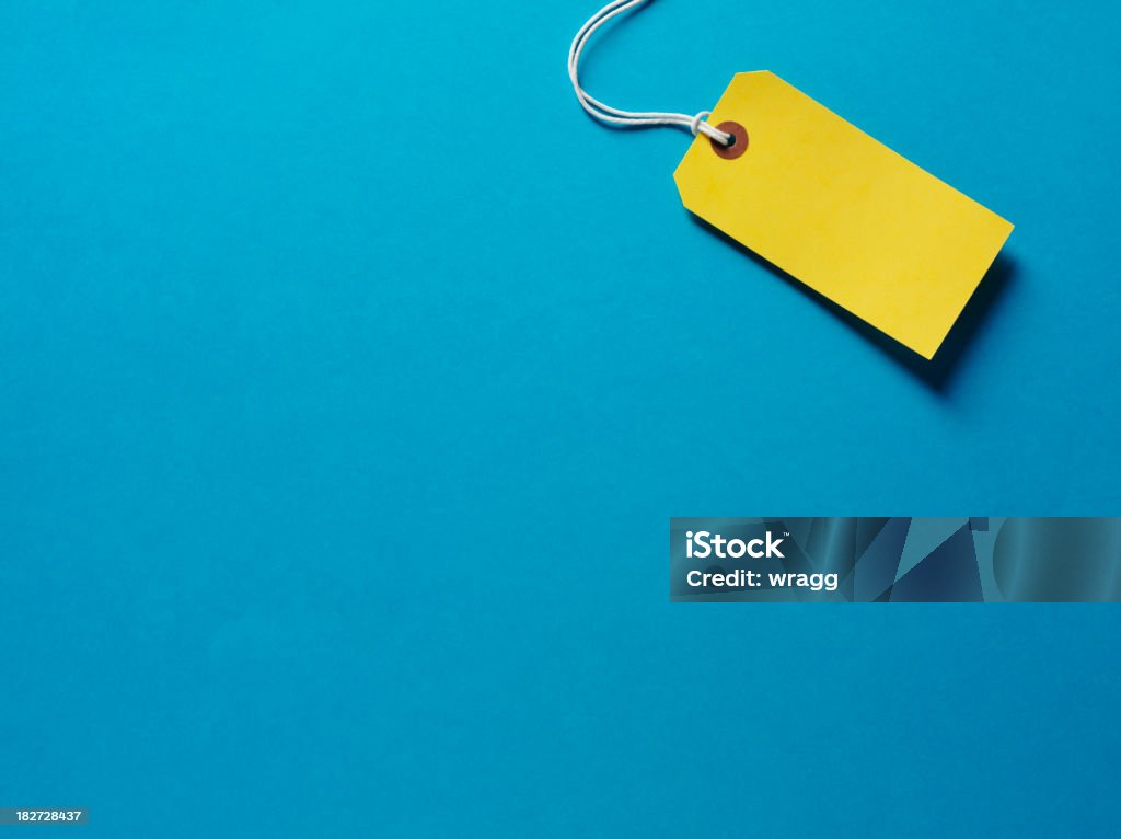 Amarillo etiqueta sobre un fondo azul - Foto de stock de Etiqueta de precio libre de derechos