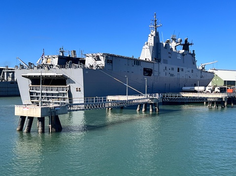 Townsville, Qld - Aug 06 2023:HMAS Adelaide mooring at Ports of Townsville.HMAS Adelaide Canberra-class landing helicopter dock ship of Royal Australian Navy the largest naval vessel ever built for Au