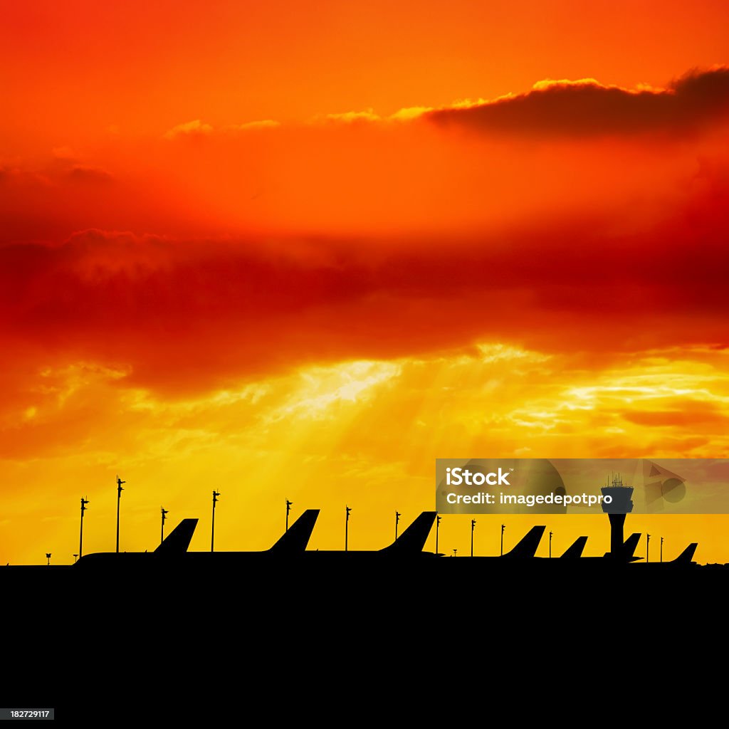 airport airport and  airplanes silhouetted by sunset.   Air Traffic Control Tower Stock Photo