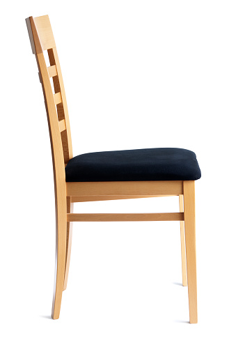 A contemporary beech side chair with black cloth seat. Side view of simple, functional, modern seating, cut out and isolated on white background, with no people. 