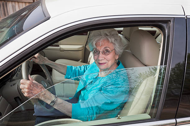 istock senior woman in car pulling out of garage 182729582