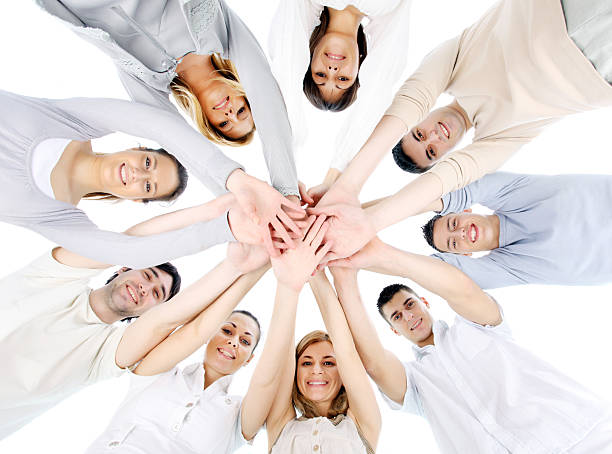 istock People holding hands on top of each other. 182729767