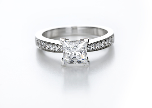 A diamond solitaire with a princess cut center stone.