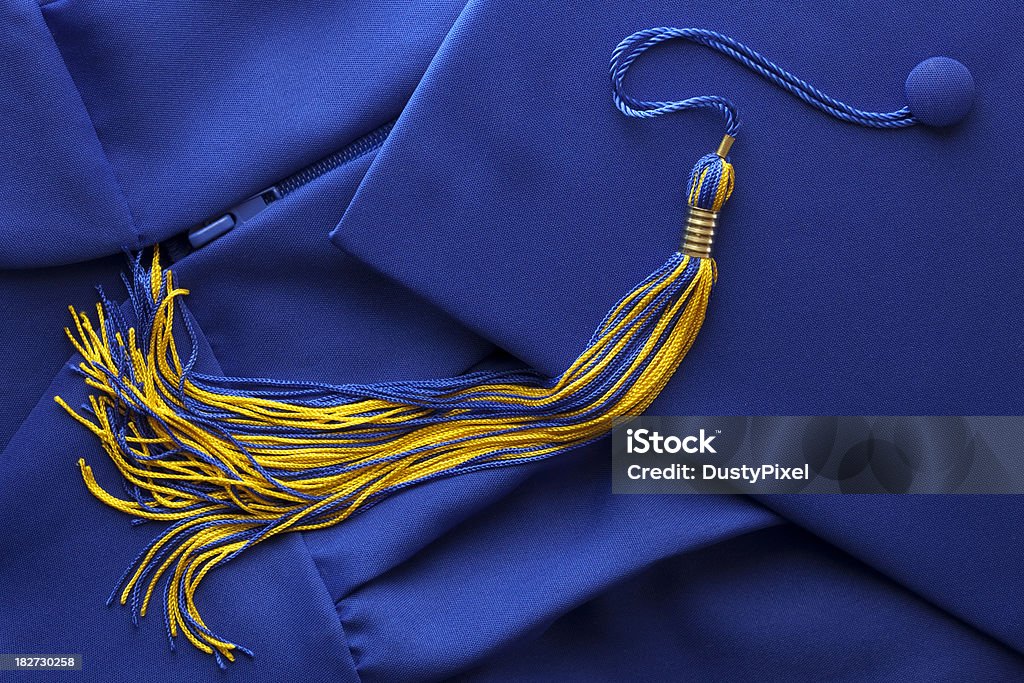 Graduation Tassel with Cap and Gown Blue and gold tassel with graduation Cap (Mortar Board) and Gown Mortarboard Stock Photo