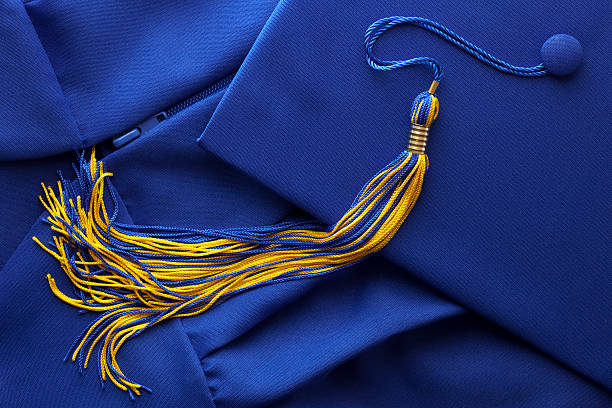 Graduation Tassel with Cap and Gown stock photo