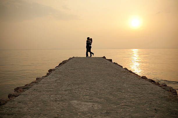 Happy couple at sunset on jetty