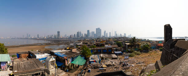 This image captures the Worli Fishing Village in Mumbai, a community steeped in traditional fishing practices, juxtaposed against the backdrop of a rapidly urbanizing city. The village's rustic charm is evident in its small, colorfully painted houses and narrow lanes. However, the photograph also reveals a less picturesque reality of the area – the issue of litter and pollution. The shores and streets are strewn with litter, reflecting a lack of adequate maintenance and waste management in this part of the city. Boats, both docked and preparing to set sail, are seen amidst this setting, symbolizing the daily challenges faced by the community. This image aims to highlight not just the cultural richness and simplicity of life in the Worli Fishing Village, but also the environmental and infrastructural issues that impact it, offering a candid look at the complexities of life in one of Mumbai's oldest fishing communities.