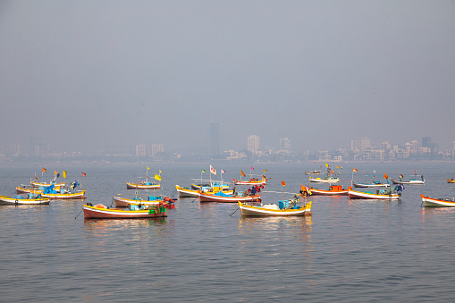 This image captures the Worli Fishing Village in Mumbai, a community steeped in traditional fishing practices, juxtaposed against the backdrop of a rapidly urbanizing city. The village's rustic charm is evident in its small, colorfully painted houses and narrow lanes. However, the photograph also reveals a less picturesque reality of the area – the issue of litter and pollution. The shores and streets are strewn with litter, reflecting a lack of adequate maintenance and waste management in this part of the city. Boats, both docked and preparing to set sail, are seen amidst this setting, symbolizing the daily challenges faced by the community. This image aims to highlight not just the cultural richness and simplicity of life in the Worli Fishing Village, but also the environmental and infrastructural issues that impact it, offering a candid look at the complexities of life in one of Mumbai's oldest fishing communities.